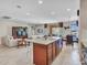 Open-concept living room showcasing an island, tile flooring, and abundant natural light at 15216 W Westview Dr, Goodyear, AZ 85395