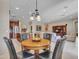 Inviting living room featuring a charming dining area and seamless flow into the kitchen at 15216 W Westview Dr, Goodyear, AZ 85395