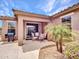 Outdoor covered patio features a dining set, grill, and lush landscaping at 15216 W Westview Dr, Goodyear, AZ 85395