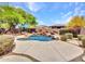 Backyard boasts a rock waterfall pool, lush plants, and a lounge deck for relaxing at 15216 W Westview Dr, Goodyear, AZ 85395