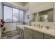 Bathroom features a large window, double vanity and wood-look tile flooring at 15217 N 15Th Dr, Phoenix, AZ 85023