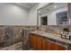 A uniquely tiled bathroom features a sink with under cabinet storage and a decorative mirror at 15217 N 15Th Dr, Phoenix, AZ 85023