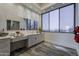 Bright bathroom with dual sinks, vanity, and an expansive window showcasing an outside view at 15217 N 15Th Dr, Phoenix, AZ 85023