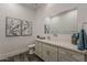 Well-lit bathroom featuring a single sink, gray cabinets, and modern fixtures at 15217 N 15Th Dr, Phoenix, AZ 85023