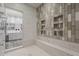 This luxurious shower with built-in bench also features views of the primary bathroom vanity and tub at 15217 N 15Th Dr, Phoenix, AZ 85023