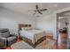 Bedroom features a bed with built in storage, hard wood floors, and a cozy recliner at 15217 N 15Th Dr, Phoenix, AZ 85023
