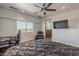 Bedroom with a large window, ceiling fan, TV, desk, and modern furniture at 15217 N 15Th Dr, Phoenix, AZ 85023