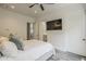 Bedroom featuring a ceiling fan and a doorway that opens to a bathroom at 15217 N 15Th Dr, Phoenix, AZ 85023
