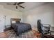 Bedroom features a desk, modern decor, a ceiling fan, and wood flooring at 15217 N 15Th Dr, Phoenix, AZ 85023