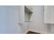 Open closet with white shelving on white walls with tile flooring at 15217 N 15Th Dr, Phoenix, AZ 85023