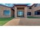 Welcoming front entrance with stone columns and sleek, modern glass doors at 15217 N 15Th Dr, Phoenix, AZ 85023
