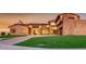 Well-manicured lawn and a stone facade highlight this elegant home's curb appeal at 15217 N 15Th Dr, Phoenix, AZ 85023