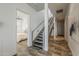 Hallway view featuring modern stairs and an open doorway view to a bedroom at 15217 N 15Th Dr, Phoenix, AZ 85023