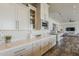 Bright kitchen features white cabinets, patterned backsplash, quartz counters, and stainless-steel appliances at 15217 N 15Th Dr, Phoenix, AZ 85023