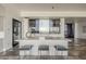 Bright kitchen island featuring a stone countertop, pendant lighting, and stainless steel chairs at 15217 N 15Th Dr, Phoenix, AZ 85023