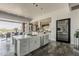 Kitchen island with white cabinets, stone countertop, and stainless steel appliances in a modern home at 15217 N 15Th Dr, Phoenix, AZ 85023