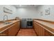 Well-organized laundry room with counter space, sink, and modern washer and dryer at 15217 N 15Th Dr, Phoenix, AZ 85023