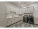 Well-equipped laundry room with modern appliances, built-in cabinets, and quartz countertops at 15217 N 15Th Dr, Phoenix, AZ 85023