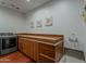 Functional laundry area with wood countertops, storage, and modern appliances at 15217 N 15Th Dr, Phoenix, AZ 85023
