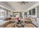 Spacious living room with tile flooring, comfortable sofas, and an open layout into the kitchen at 15217 N 15Th Dr, Phoenix, AZ 85023