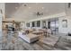 Open-concept living area with modern decor, tile flooring, and a view of the well-appointed kitchen at 15217 N 15Th Dr, Phoenix, AZ 85023