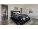 The main bedroom showcases a stylish bed with a tufted headboard, textured walls, and elegant decor at 15217 N 15Th Dr, Phoenix, AZ 85023