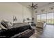 Large primary bedroom boasts a ceiling fan, TV, comfortable seating and a view of the beautiful backyard at 15217 N 15Th Dr, Phoenix, AZ 85023