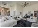 Spacious primary bedroom features a high ceiling with ceiling fan, stone accent wall, and luxury furniture at 15217 N 15Th Dr, Phoenix, AZ 85023