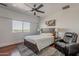 This main bedroom offers a comfortable leather recliner and a beautiful view out a large window at 15217 N 15Th Dr, Phoenix, AZ 85023