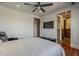 A comfortable main bedroom with wood floors, TV, and attached bathroom and walk-in closet at 15217 N 15Th Dr, Phoenix, AZ 85023