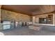 Outdoor kitchen featuring stainless steel appliances, stone fire pit, and covered living area at 15217 N 15Th Dr, Phoenix, AZ 85023