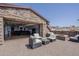 Inviting outdoor patio with stone accents, comfortable seating, and seamless indoor-outdoor living at 15217 N 15Th Dr, Phoenix, AZ 85023