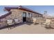A charming outdoor patio with stone walls, with seating for four, perfect for entertaining or relaxing at 15217 N 15Th Dr, Phoenix, AZ 85023