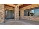 Covered outdoor patio area features stone accents, large windows, and interlocking brick ground cover at 15217 N 15Th Dr, Phoenix, AZ 85023