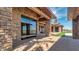 Open patio has brick ground cover and stone pillars plus views of the outdoor landscaping and pool at 15217 N 15Th Dr, Phoenix, AZ 85023