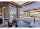 Workout room extending to a patio featuring an exercise bike and views at 15217 N 15Th Dr, Phoenix, AZ 85023