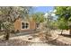 Landscaped backyard with mature trees, stone accents, and an inviting atmosphere at 17132 W Tara Ln, Surprise, AZ 85388