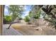 A well-kept backyard showcasing mature trees, custom pavers, and gravel landscaping at 17132 W Tara Ln, Surprise, AZ 85388