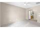 Large main bedroom with grey carpet and access to an attached bathroom at 17132 W Tara Ln, Surprise, AZ 85388