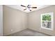 Bright bedroom with carpet flooring, neutral colors, a ceiling fan and a window at 17132 W Tara Ln, Surprise, AZ 85388