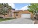 Charming single-Gathering home with a two-car garage and stone accents on a sunny day at 17132 W Tara Ln, Surprise, AZ 85388