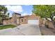 Charming single-Gathering home with a two-car garage and stone accents on a sunny day at 17132 W Tara Ln, Surprise, AZ 85388