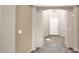 Bright foyer with decorative light fixture, neutral walls and tiled floors at 17132 W Tara Ln, Surprise, AZ 85388