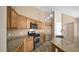 Well-equipped kitchen with stainless steel appliances, granite countertops, and wood cabinetry at 17132 W Tara Ln, Surprise, AZ 85388