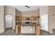 Bright kitchen featuring an island, granite counters, updated appliances and lovely pendant lights at 17132 W Tara Ln, Surprise, AZ 85388