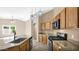 Bright kitchen featuring stainless steel appliances, granite counters, and lovely pendant lights at 17132 W Tara Ln, Surprise, AZ 85388