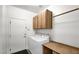 Well-equipped laundry room with washer, dryer, storage cabinets, and ample counter space at 17132 W Tara Ln, Surprise, AZ 85388