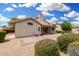 Desert landscaped backyard featuring a covered patio, brick patio, and desert landscaping, perfect for outdoor enjoyment at 19029 N 36Th St, Phoenix, AZ 85050