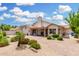 Expansive backyard featuring desert landscaping, paver patio and low walls with bushes, and covered patio for outdoor living at 19029 N 36Th St, Phoenix, AZ 85050