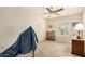 Bedroom with neutral carpet, a ceiling fan, window shutters, and a small side table at 19029 N 36Th St, Phoenix, AZ 85050